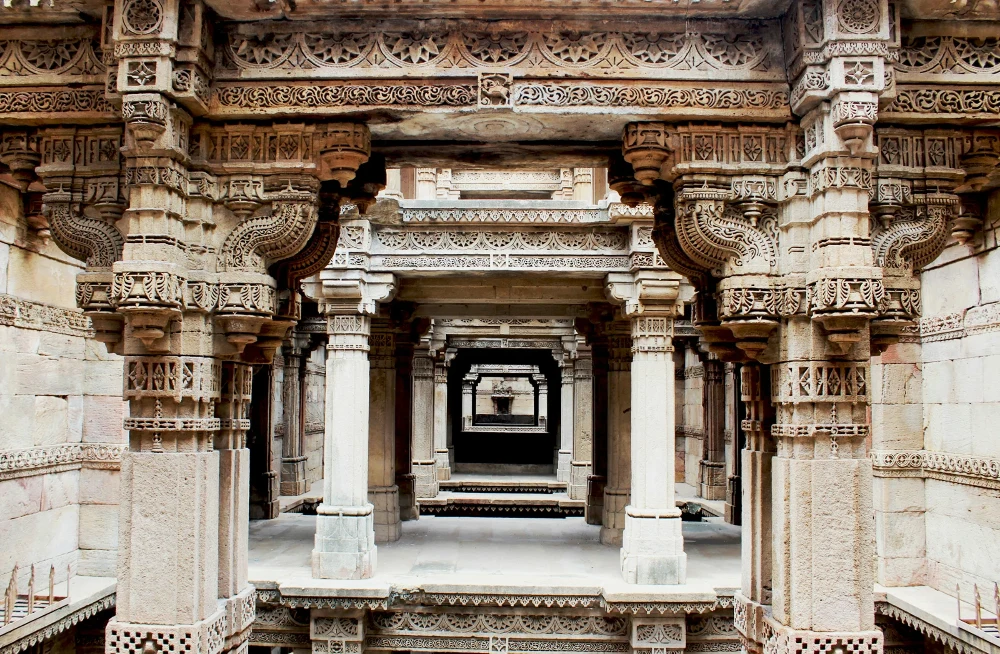 Successive stone doorways form a deep corridor framed by elaborately carved pillars.