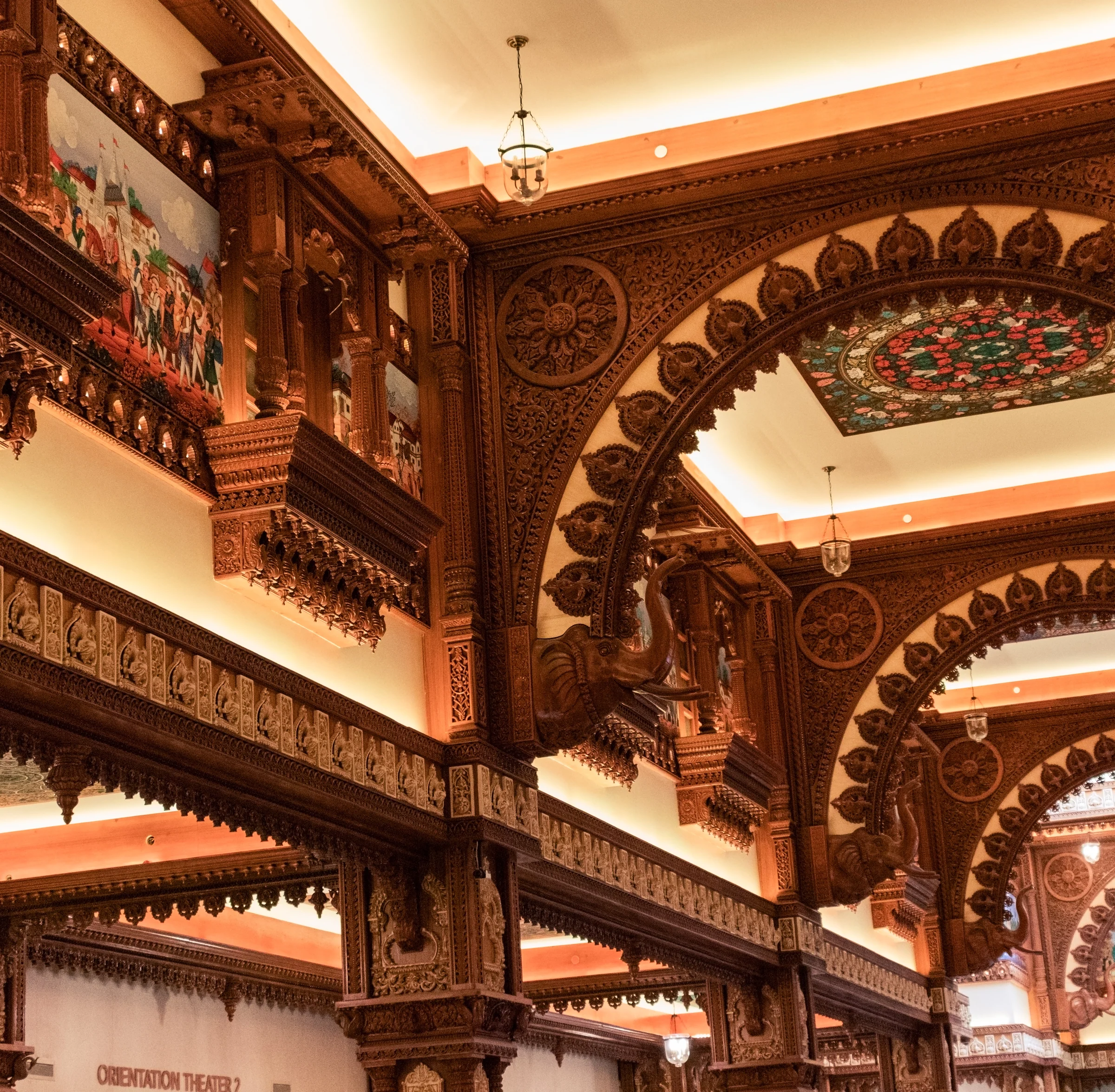 Warm interior lighting reveals richly carved wooden arches and decorative panels.