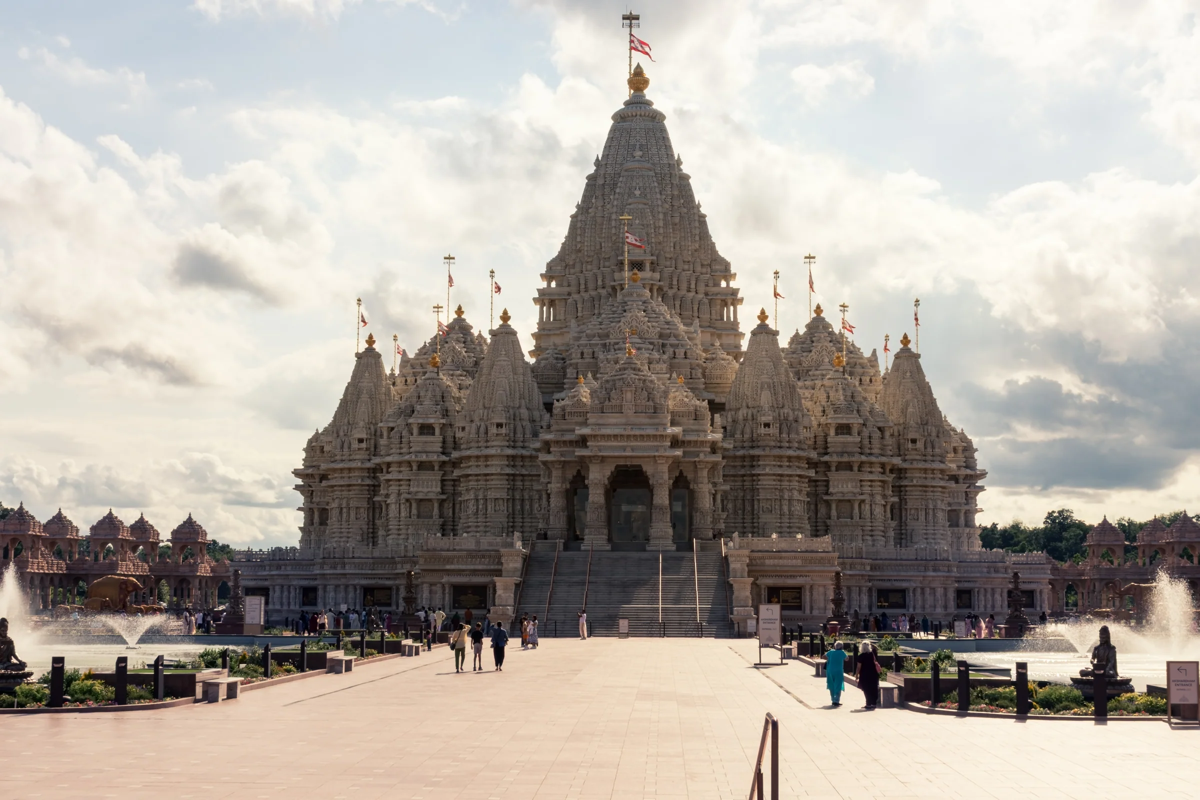 An ornate stone temple overlooks a broad sunlit courtyard.